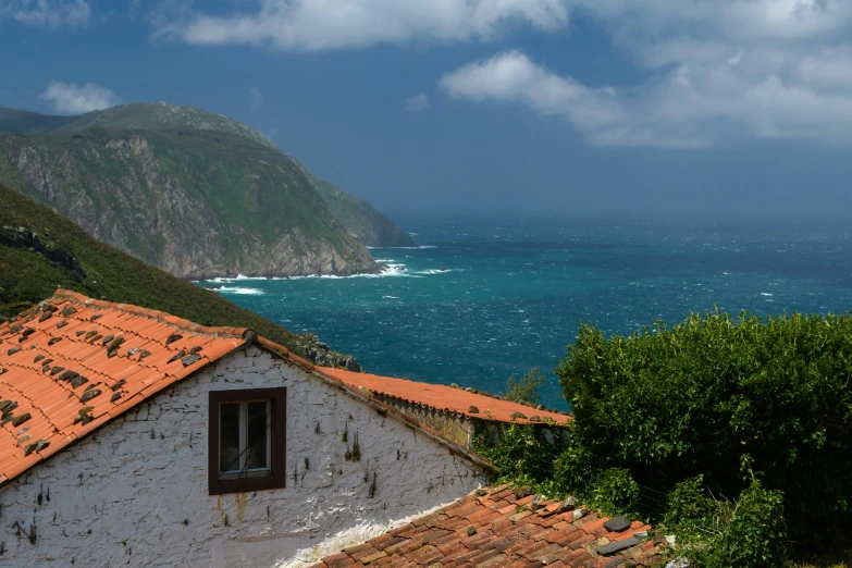 a view of the ocean and a house on top of it