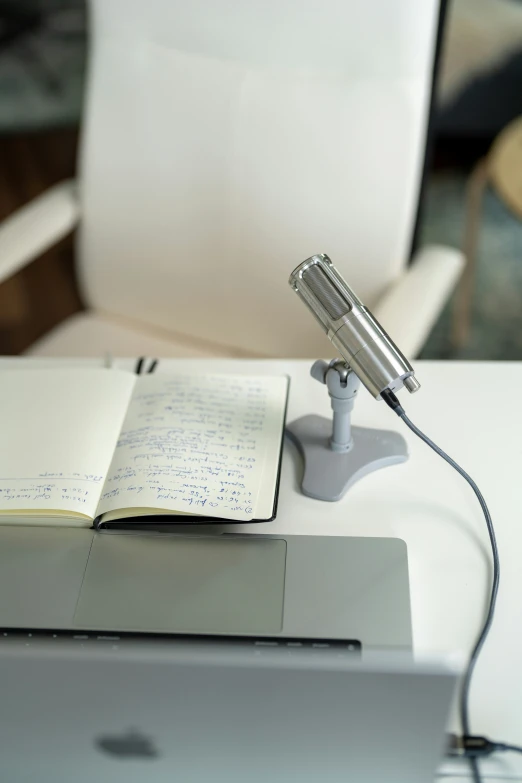 a white chair a desk with a laptop and pen