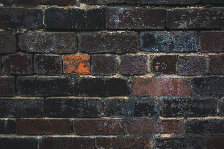 a brick wall with rust and mortared up in squares