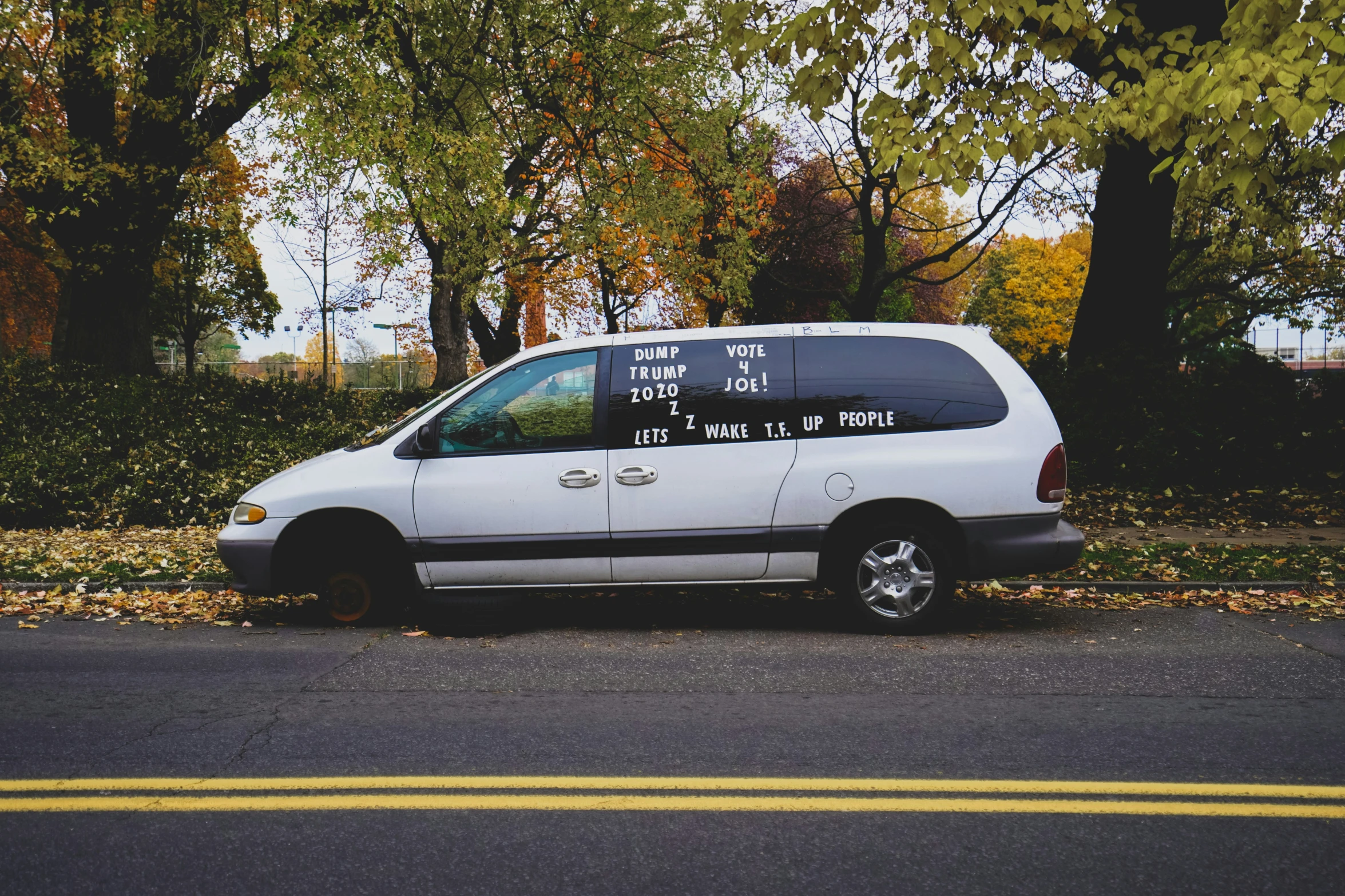 the van is parked on the side of the road