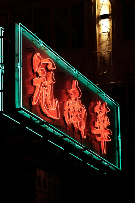 there is a neon sign with chinese words in red and green