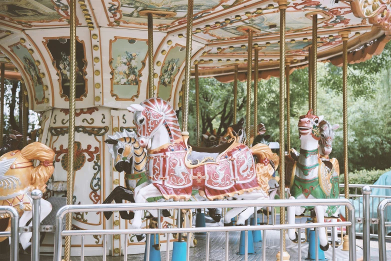 there is a large merry go round with many horses