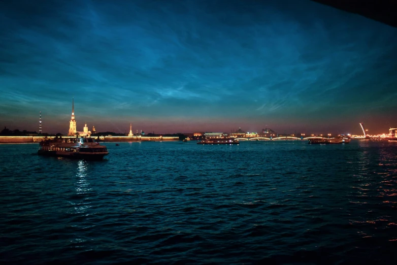 a boat in the ocean at night on a body of water