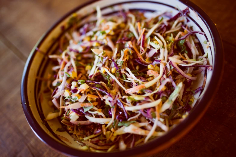 a colorful salad in a bowl on top of a table