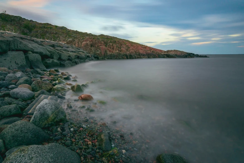 low water on a cliff face covered by grass and rocks