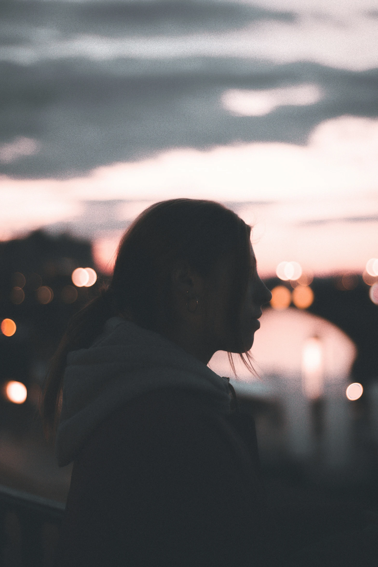 a person standing on a ledge at sunset