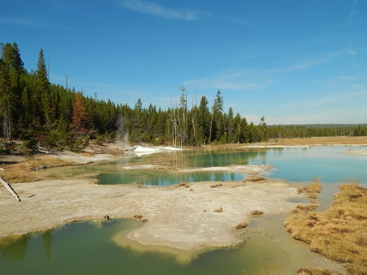 the blue pond has steam rising out of it