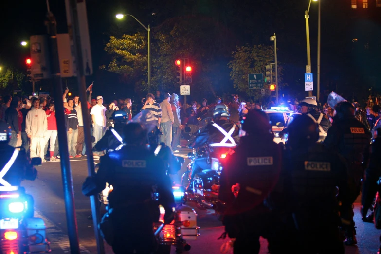 a large crowd of people gathered at a street corner