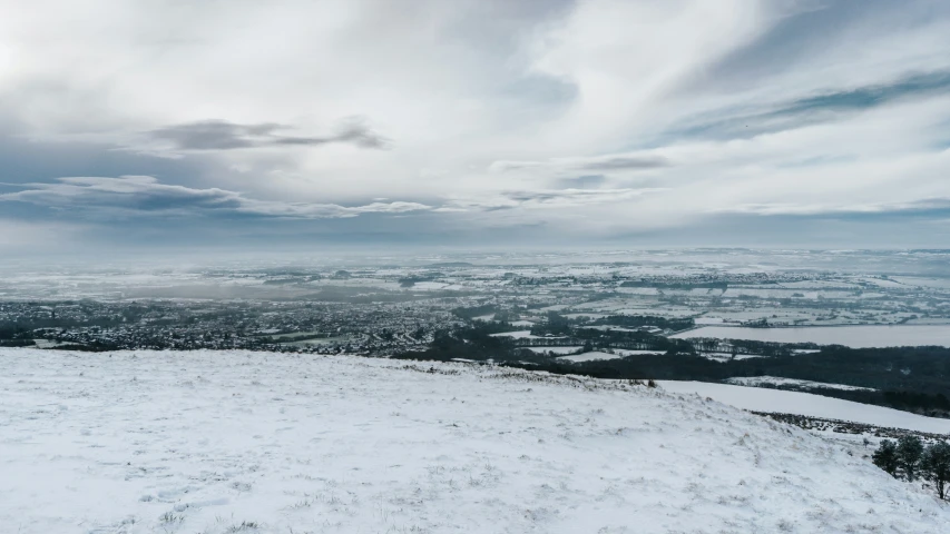 a skier looking over a snowy landscape in winter