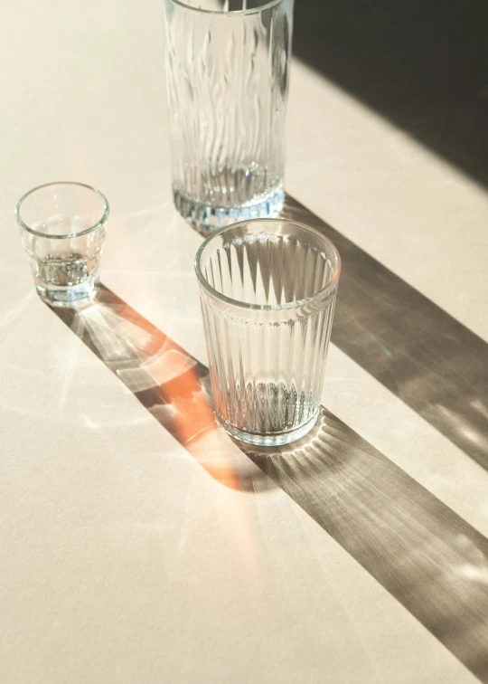 a glass next to two empty s glasses