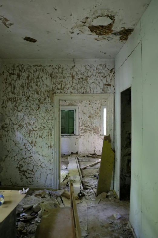 an abandoned kitchen in disrepair with no people inside