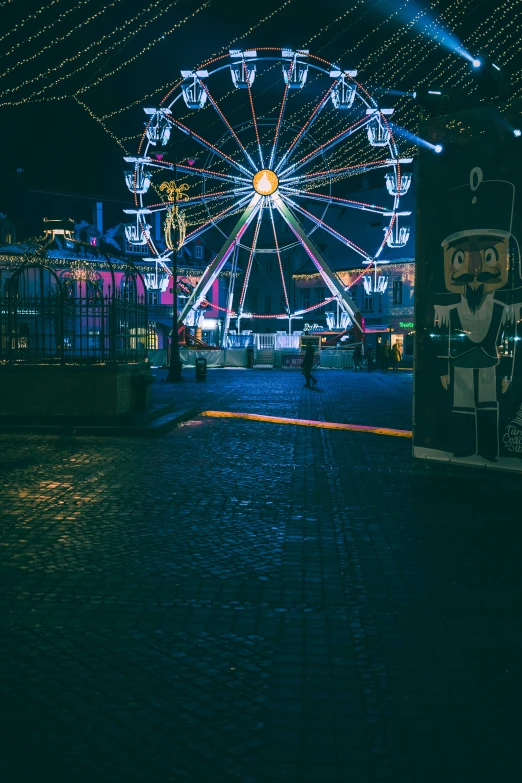 a ferris wheel sitting in front of a lit up building