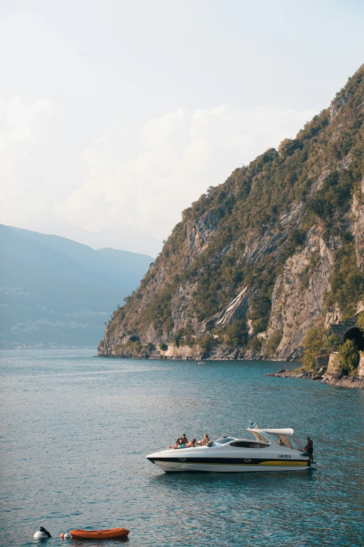 two boats anchored near a mountain lake