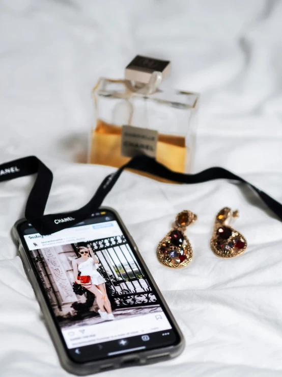 an ipod on a bed with a picture of two woman sitting at the foot of a man