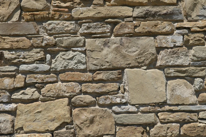 a close up of an old brick wall with a cat face painted on it