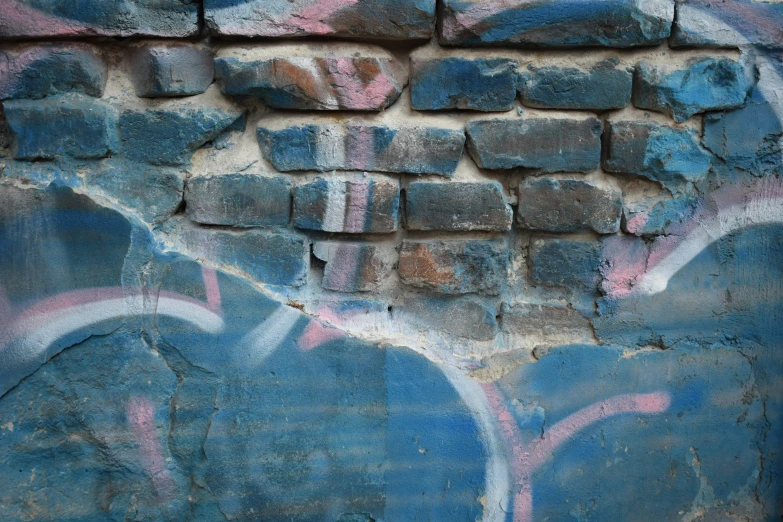 graffiti painted on a brick wall that has been graffitted