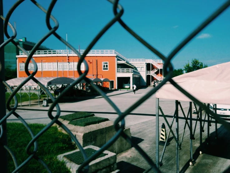 the fence is by the building and it is closed