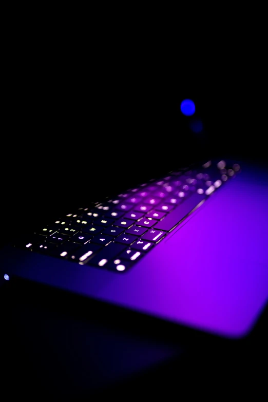the keyboard has purple and black lights on it