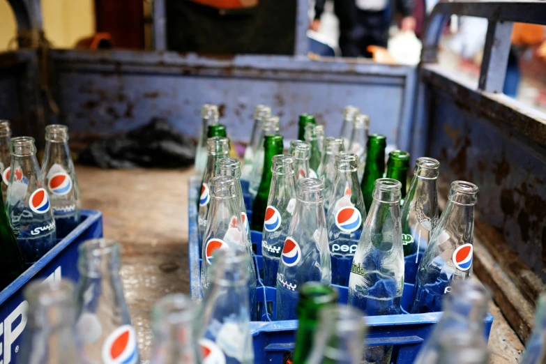 lots of soda bottles in a crate at a market