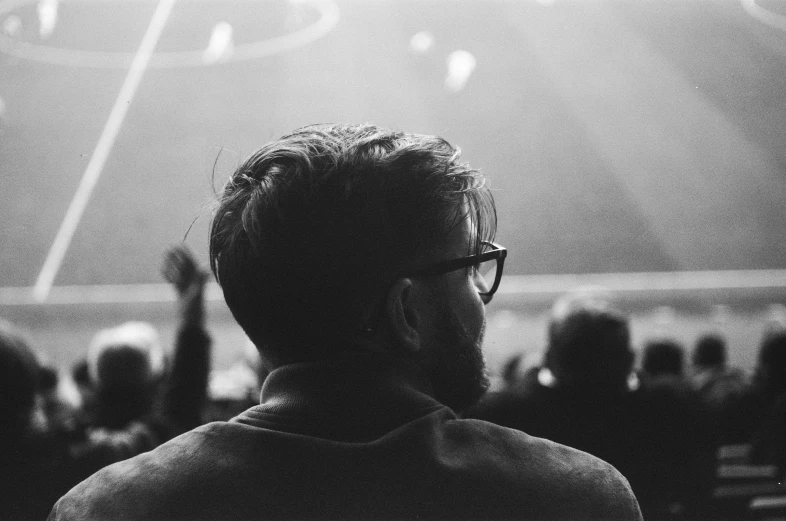 a man looks at an arena during a concert