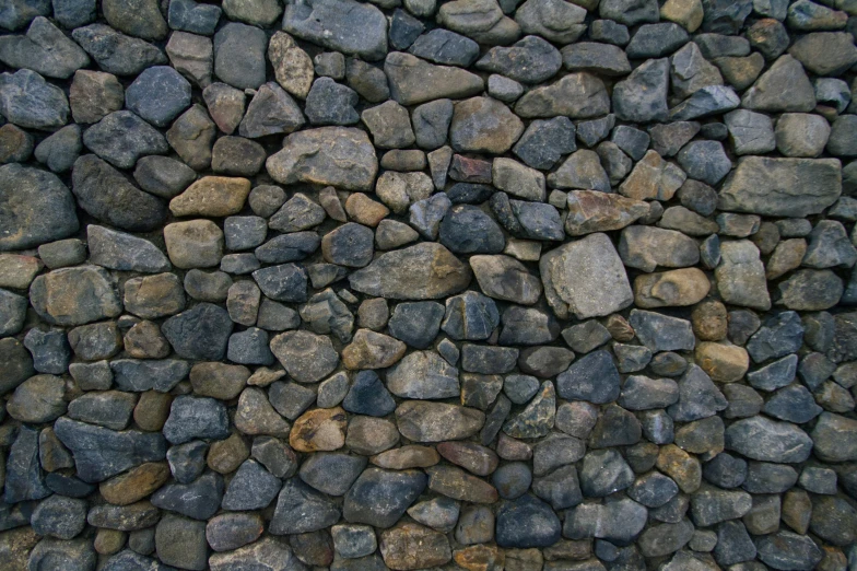 there is a large number of rocks and a stone wall