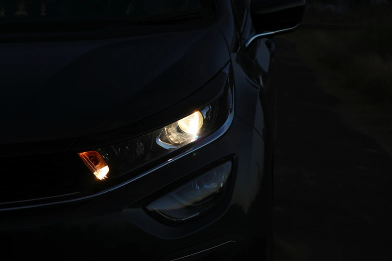 headlights and headlights on a black car at night