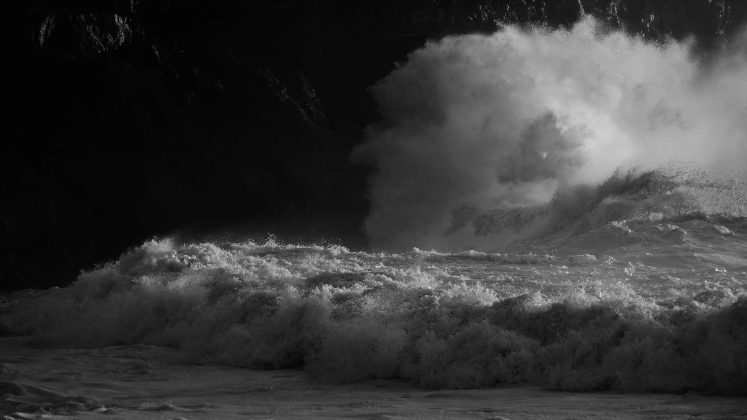 the large waves crashing onto the beach