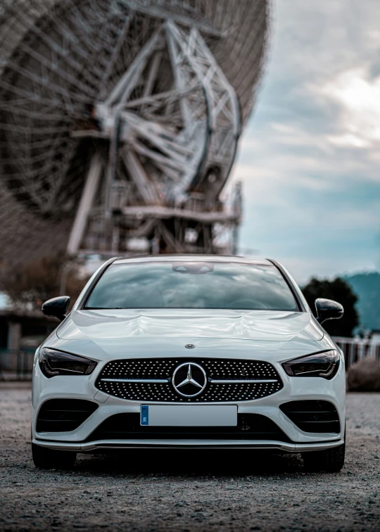 the mercedes cla driving past an antenna