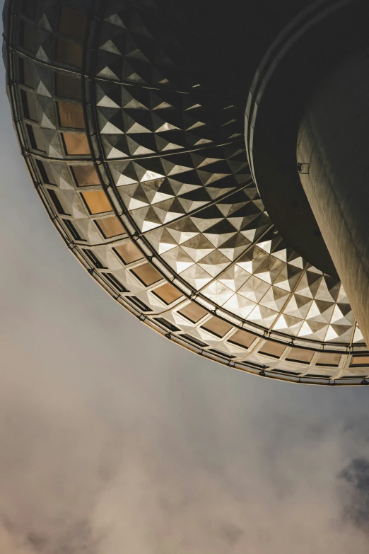 looking up at the base of a building under clouds