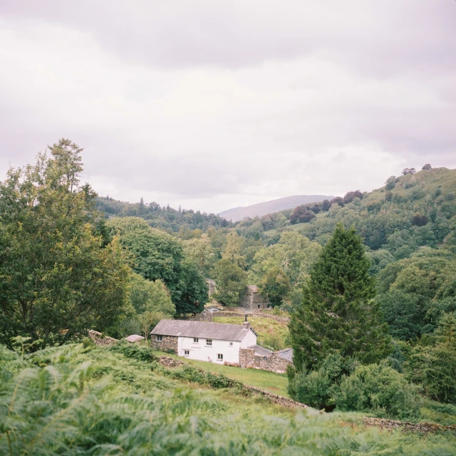 an over head view of a farm house and forest