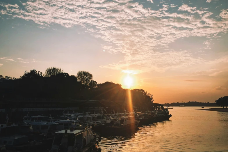 a boat is out on the water at sunrise