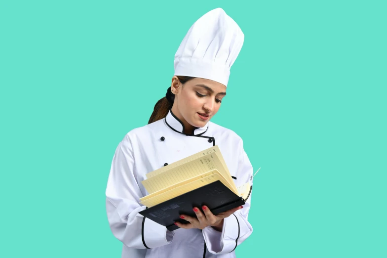 a female cook is holding a recipe book
