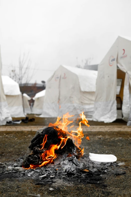 a camp fire with camp chairs on it