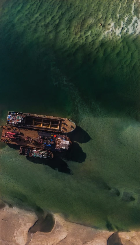 two boats in the water near a shoreline