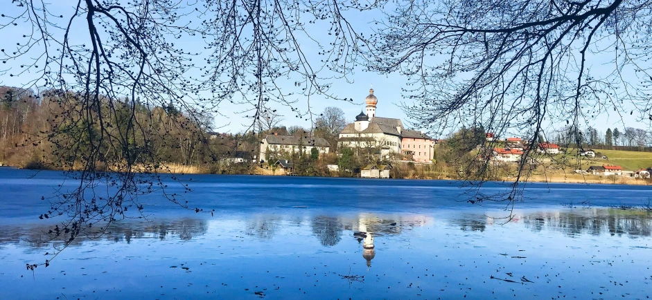 a view of a church and a body of water that is covered in drops