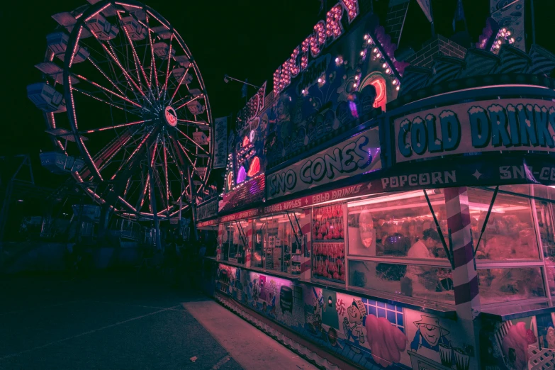 the old carnival rides and ferris wheel are very vivid
