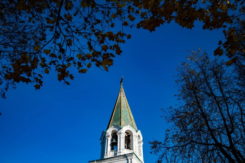 a steeple on the top of an old church with a clock