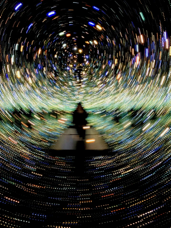 a person is standing in front of a wall of lights