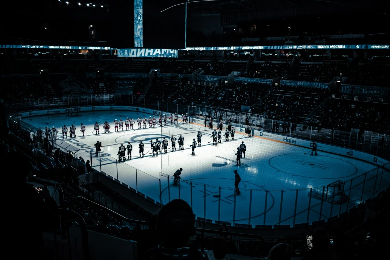 the light is on in the rink as hockey players are gathered