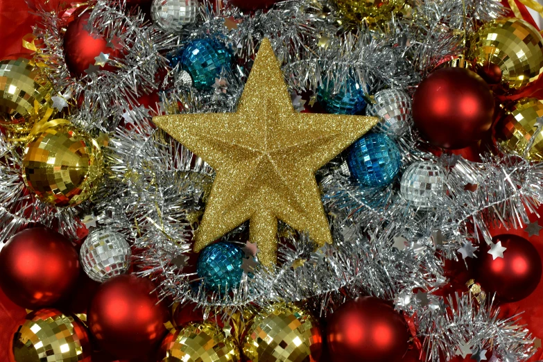 a star on a christmas wreath surrounded by ornaments