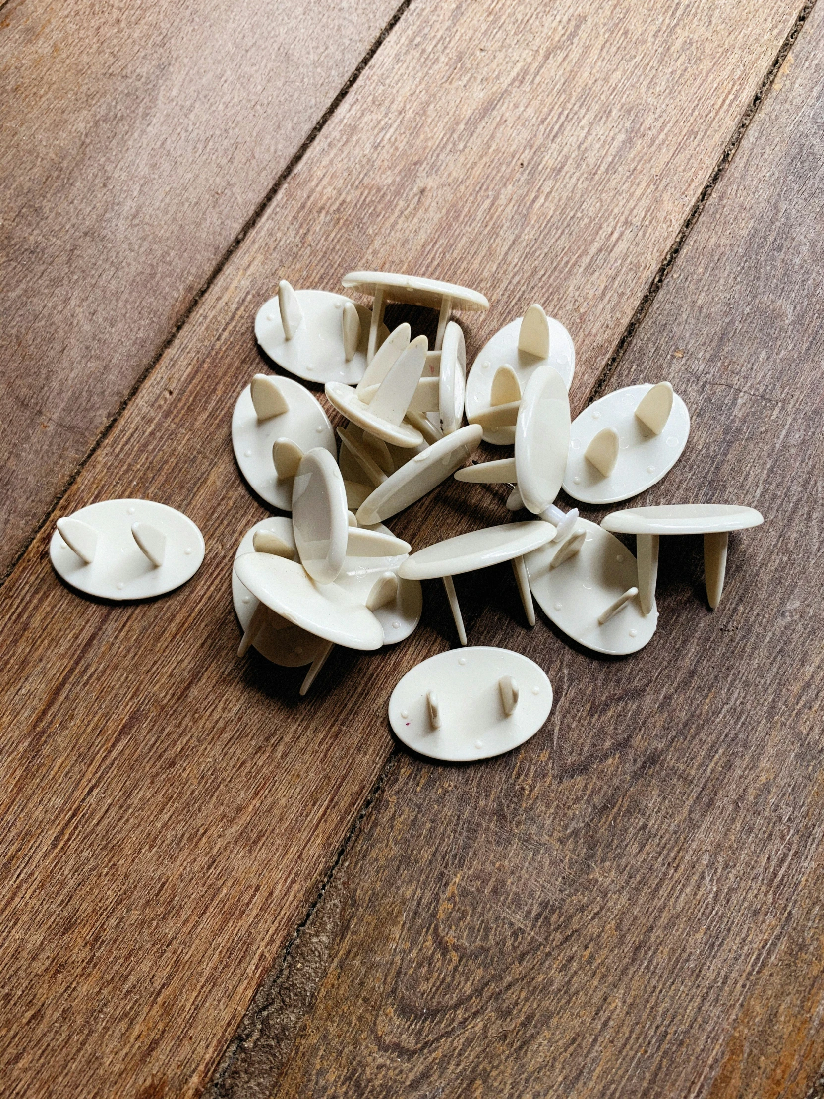 white plastic cut - out objects on top of wood