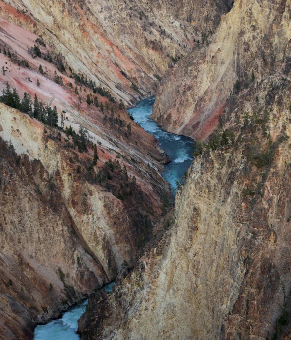 a mountain river cuts through the cliff side