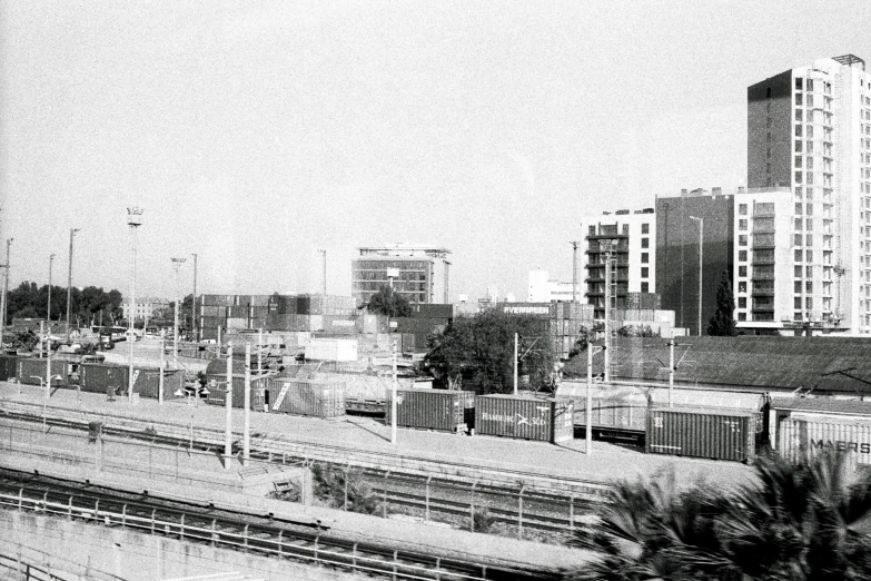 black and white pograph of a city skyline with railroad tracks