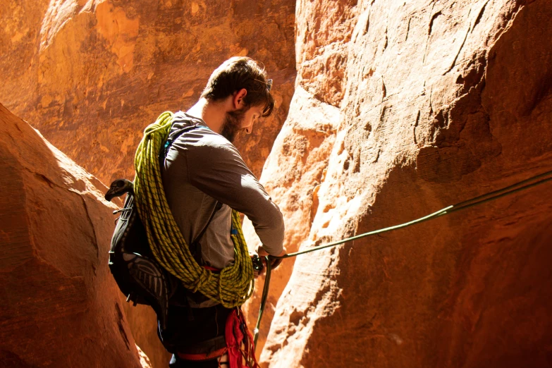 a man with a backpack climbing through an area