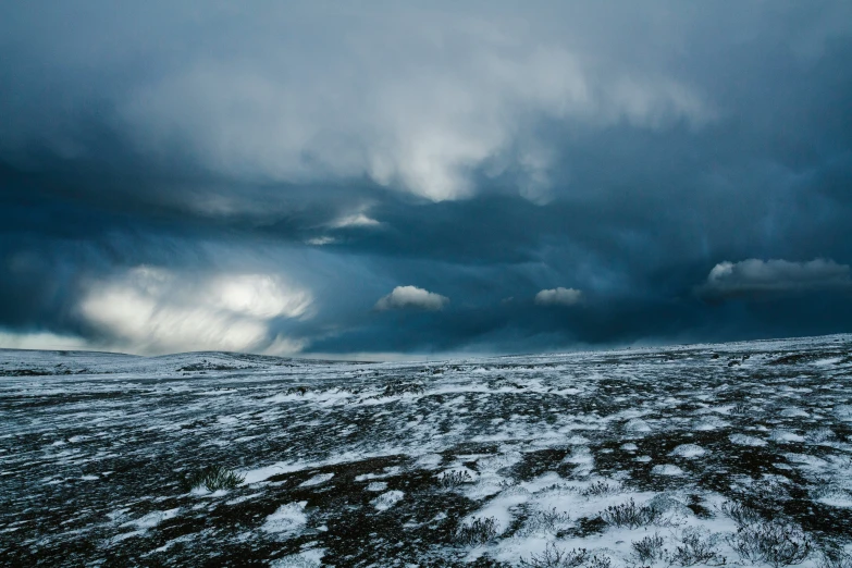 a vast wide open plain under a threatening sky