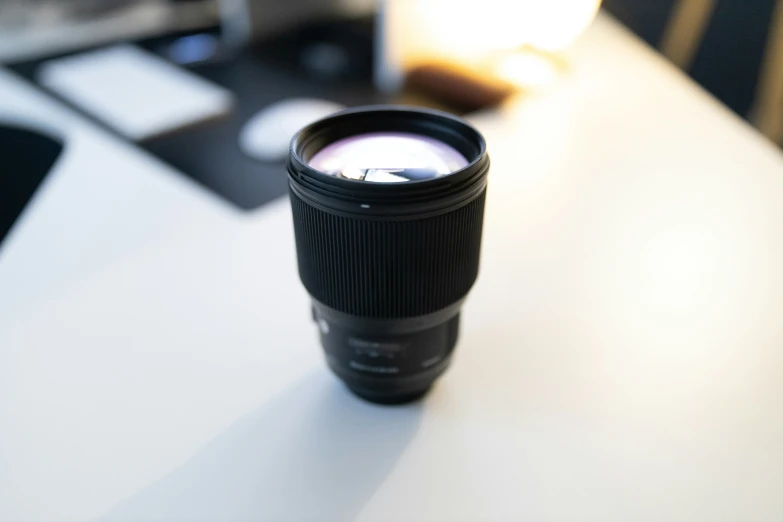 an open camera lens on a desk