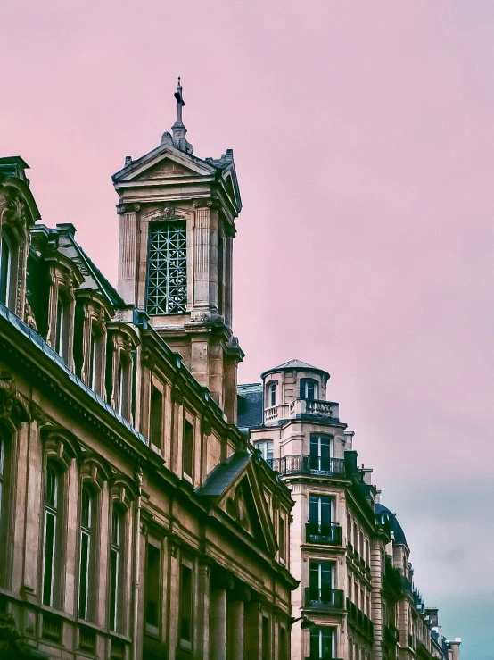 large buildings with spires line a street