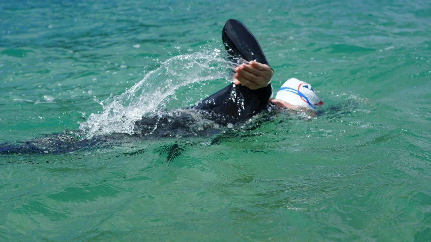 a person riding a board on top of a body of water