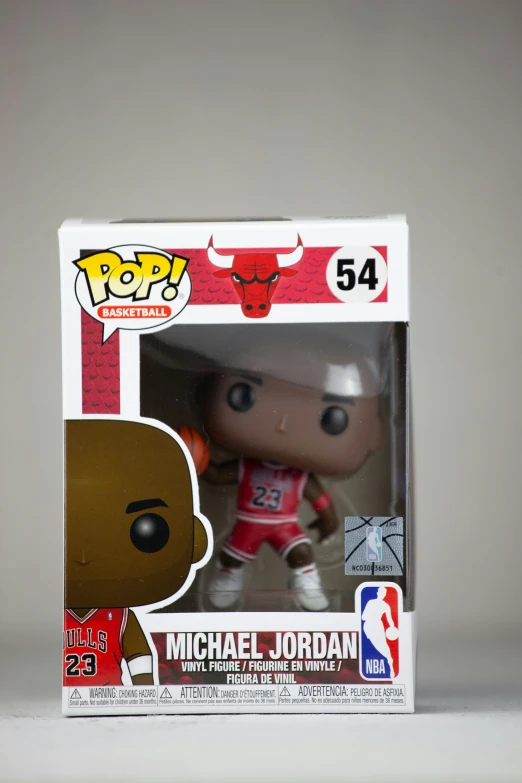 a basketball figurine in a box with a sticker on it