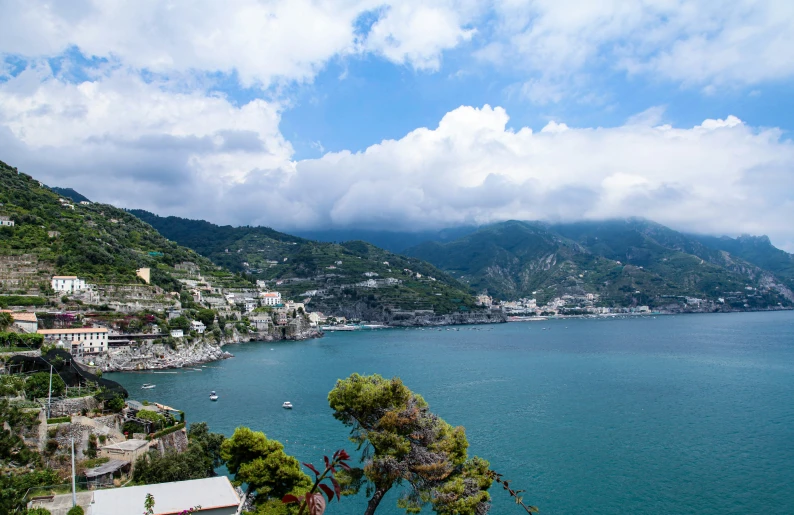 a landscape view of some houses by a large body of water